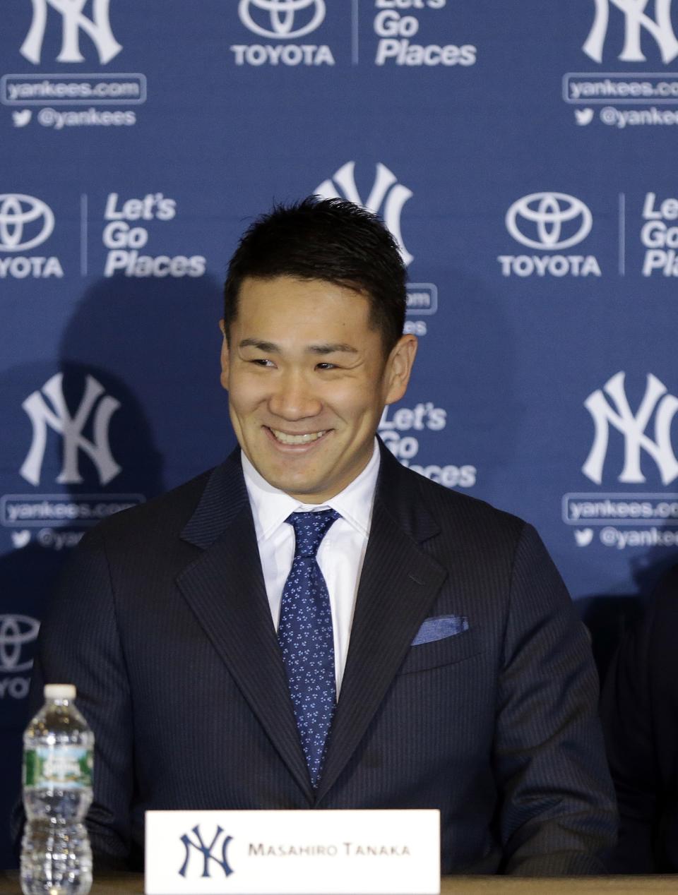 New York Yankees pitcher Masahiro Tanaka, of Japan, smiles as he arrives for a basesball news conference at Yankee Stadium Tuesday, Feb. 11, 2014, in New York. (AP Photo/Frank Franklin II)