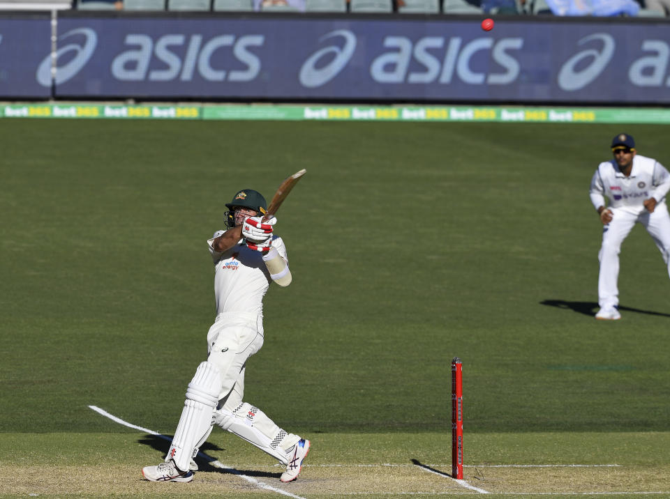 Australia's Joe Burns, left, his a 6 to win their cricket test match against India on the third day at the Adelaide Oval in Adelaide, Australia, Saturday, Dec. 19, 2020. (AP Photo/David Mariuz)