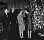 <p>On a visit to the United States in 1965 just before the holidays, British Prime Minister Harold Wilson and his wife are shown the White House Christmas tree by Lady Bird and President Johnson. </p>