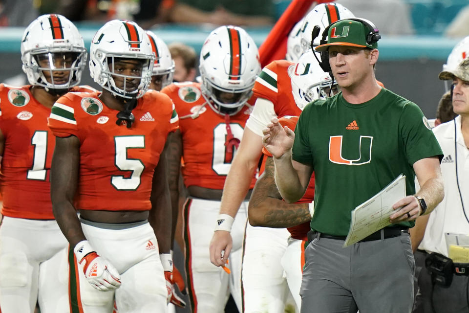 FILE - Miami offensive coordinator Rhett Lashlee watches during the second half of an NCAA college football game against Virginia, Thursday, Sept. 30, 2021, in Miami Gardens, Fla. SMU hired Rhett Lashlee as its new head coach Monday, Nov. 29, 2021, bringing back its former offensive coordinator to replace Sonny Dykes. Lashlee had been Miami's offensive coordinator for two seasons after serving as OC for the Mustangs during Dykes' first two seasons in 2018 and 2019. (AP Photo/Lynne Sladky, File)