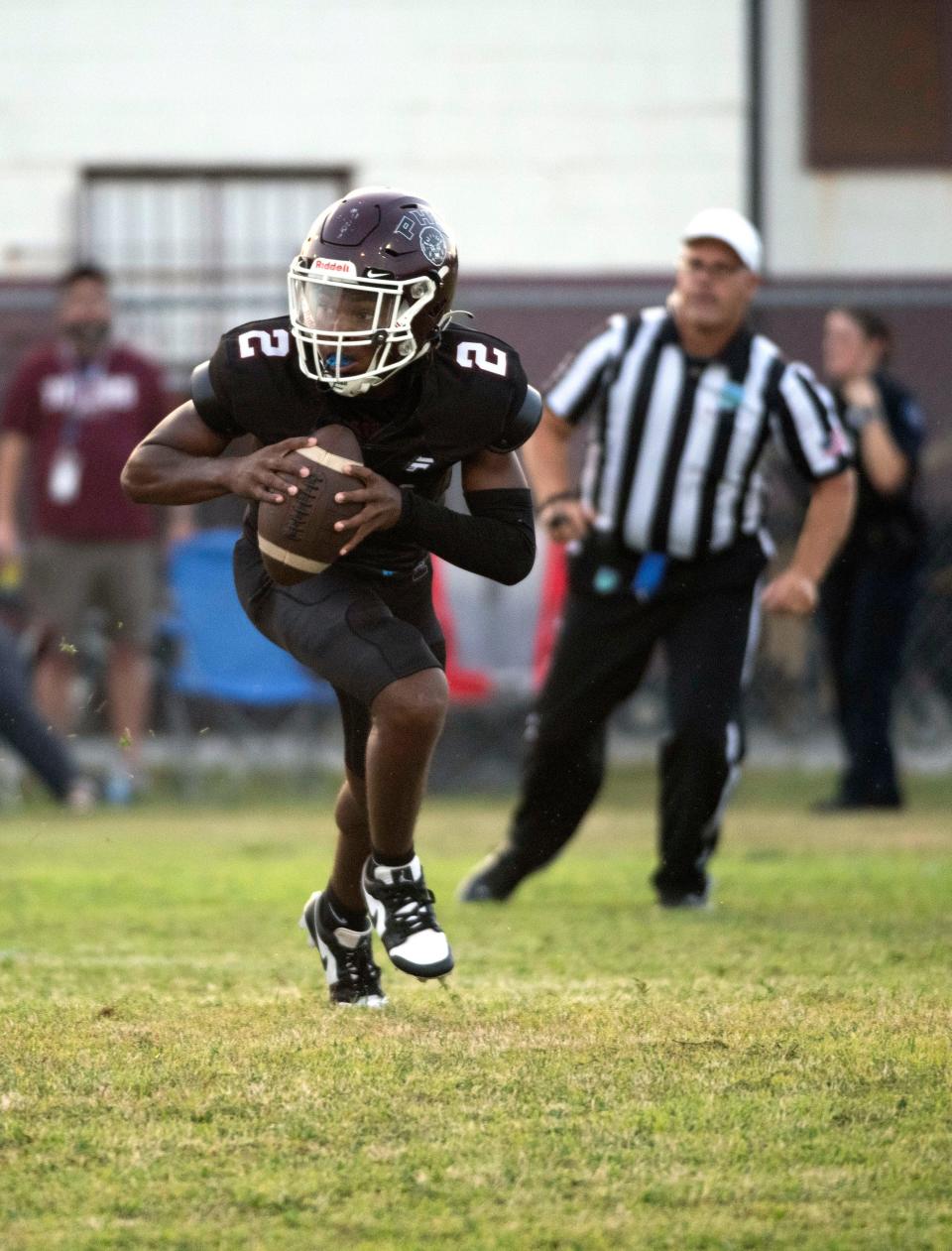 Pensacola High School's Jamarcuz Fountain (No. 2) rolls out of the pocket as he looks for an open receiver during Friday night's home opener against Washington High School.