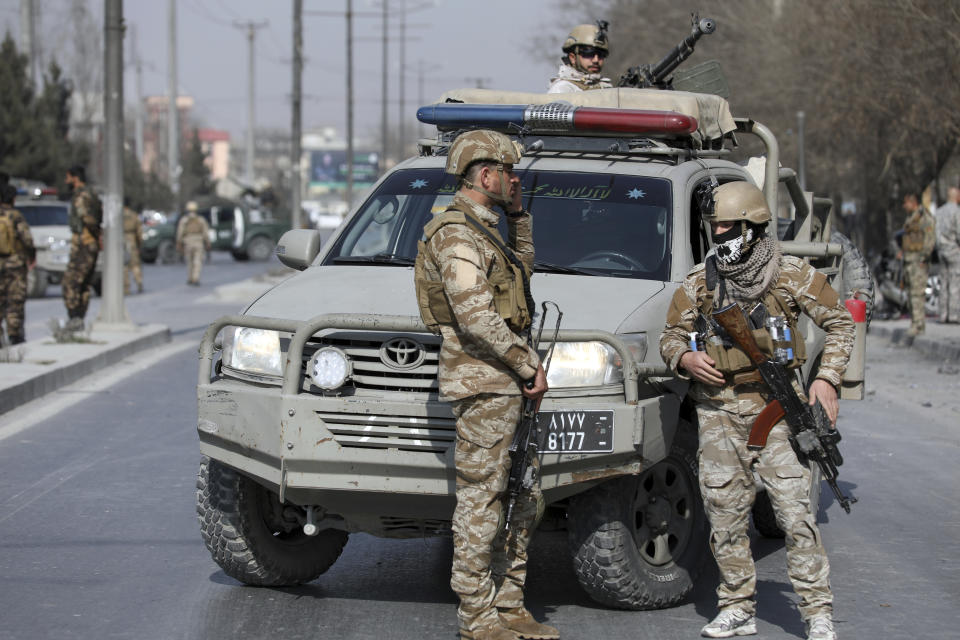 Afghan security personnel inspect the site of a deadly bomb attack in Kabul, Afghanistan, Tuesday, Feb. 9, 2021. A string of attacks on Tuesday in Afghanistan killed several government employees and several policemen. No one immediately claimed responsibility for the attacks. (AP Photo/Rahmat Gul)