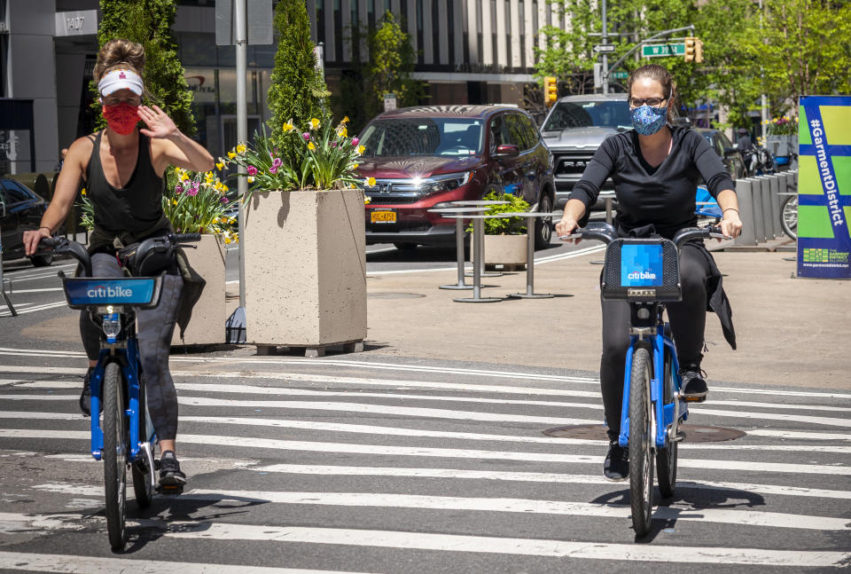 Cyclists advantage of the closed to traffic Broadway in the Garment District in New York while social distancing on Thursday. Source: AP