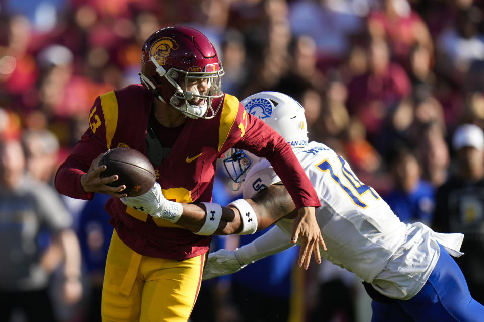 San Jose State offensive lineman Anthony Pardue (74) tries to tackle Southern California quarterback Caleb Williams (13) during the first half of an NCAA college football game in Los Angeles, Saturday, Aug. 26, 2023. (AP Photo/Jae C. Hong)