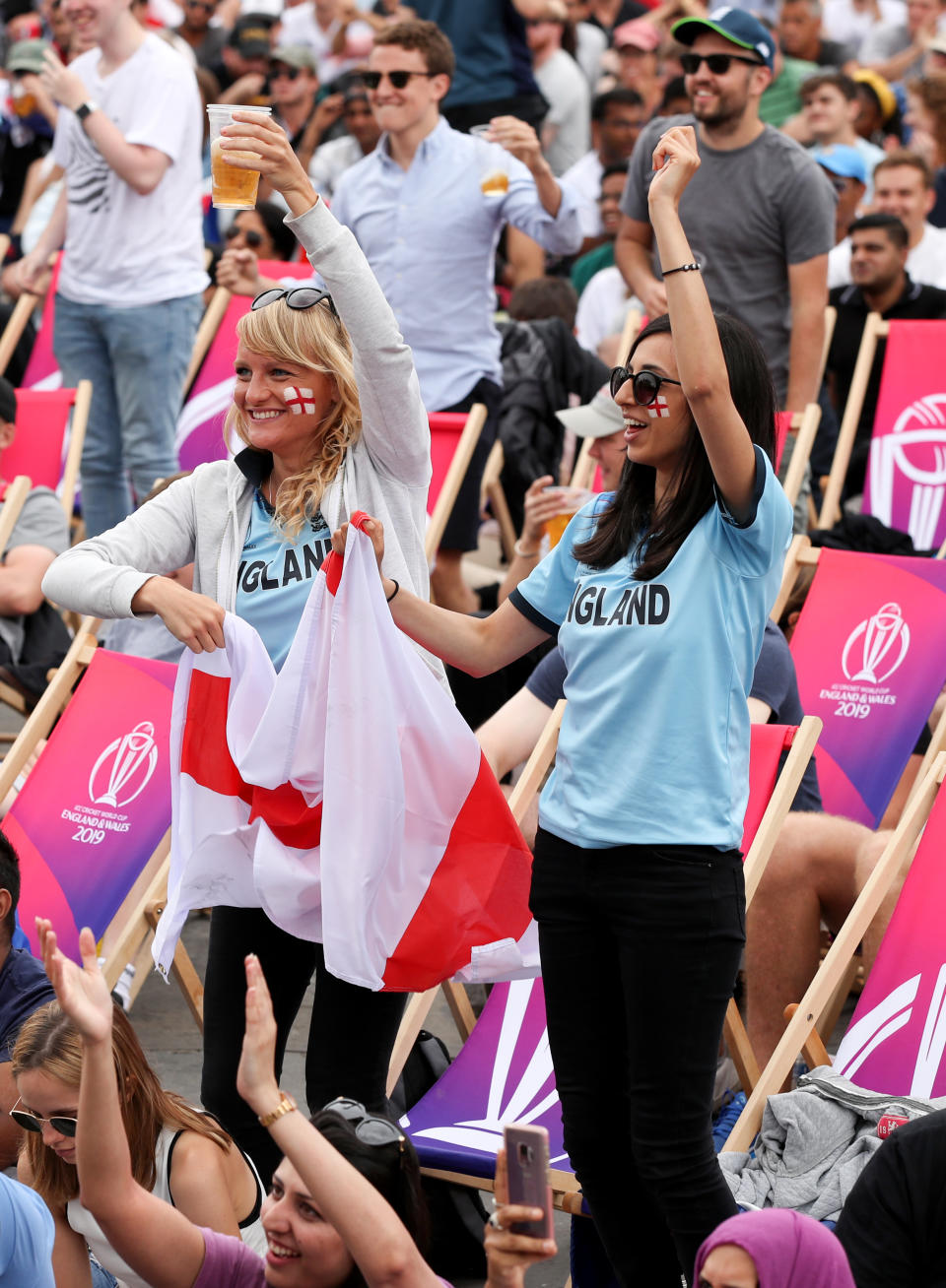 Fans celebrate the fall of New Zealand's 5th wicket as they watch a big screen in the Fanzone at Trafalgar Square during the Cricket World Cup Final between New Zealand and England at the ICC Fanzone, London.