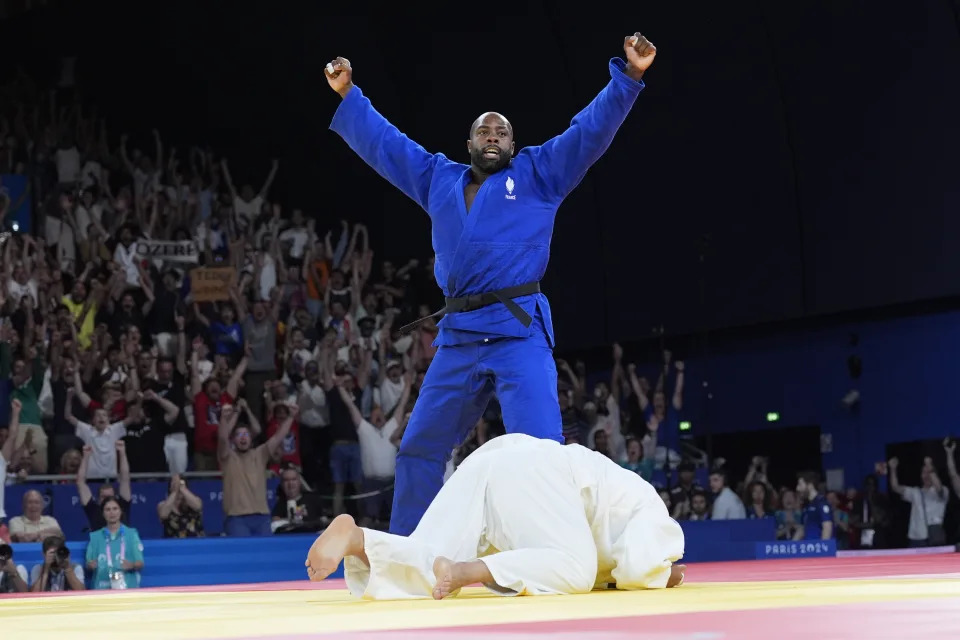 France's Teddy Riner celebrates after defeating South Korea's Kim Min-jong during their men's +100 kg final match in the team judo competition, at Champ-de-Mars Arena, during the 2024 Summer Olympics, Friday, Aug. 2, 2024, in Paris, France. (AP Photo/Eugene Hoshiko)