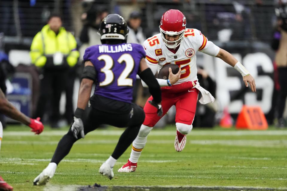 Kansas City Chiefs quarterback Patrick Mahomes (15) runs with the ball under pressure from Baltimore Ravens safety Marcus Williams (32) during the first half of the AFC Championship NFL football game, Sunday, Jan. 28, 2024, in Baltimore. (AP Photo/Nick Wass)