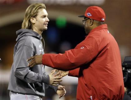 Reds manager Dusty Baker congratulates Arroyo after Cincinnati took a 2-0 lead in the NLDS. (AP)