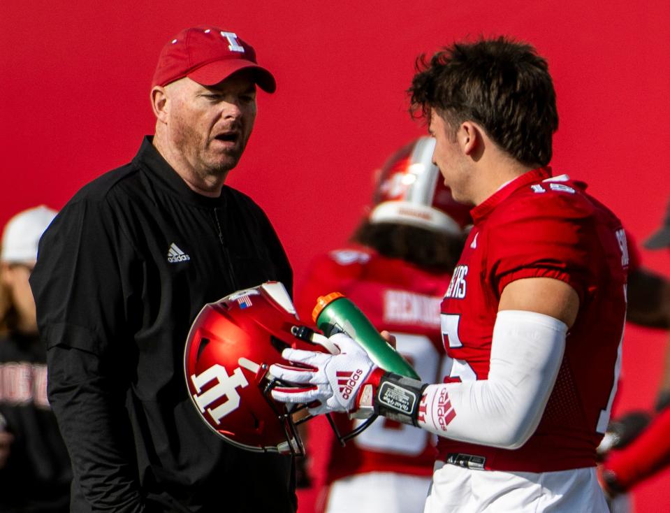 Indiana Offensive Coordinator Rod Carey talks with Brenden Sorsby (15) during pregame warm-ups before the start of the Indiana versus Rutgers football game at Memorial Stadium on Saturday, Oct. 21. 2023.