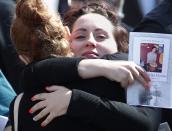 Friends hug after the funeral of Josh Hunter in Calgary, Alberta, April 21, 2014. Matthew de Grood is charged with killing Hunter and four of his friends at a house party in Calgary's worst mass murder in the history of the city, according to local media reports. REUTERS/Todd Korol (CANADA - Tags: CRIME LAW OBITUARY)