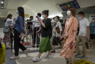 Commuters walk through a subway station during the morning rush hour in the central business district in Beijing, Tuesday, Aug. 9, 2022. China's 11 million university graduates are struggling in a bleak job market this summer as repeated shutdowns under China's anti-COVID lockdowns forced companies to retrench and driven many restaurants and other small employers out of business. (AP Photo/Mark Schiefelbein)