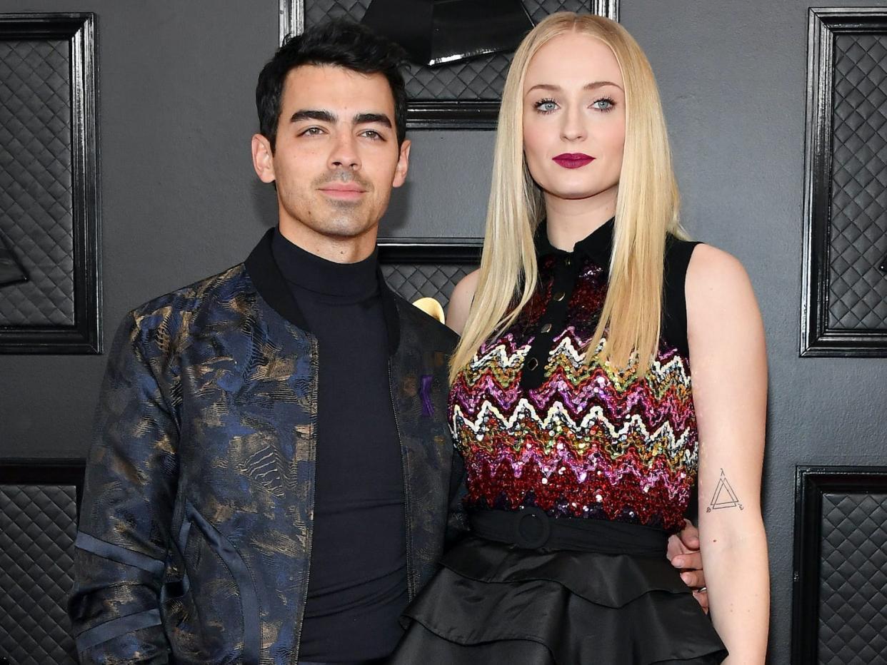 Joe Jonas and Sophie Turner being photographed at the Grammys.