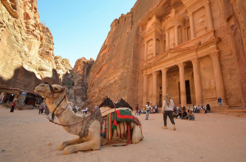 Tourists gather in front of the treasury site in the ancient city of Petra