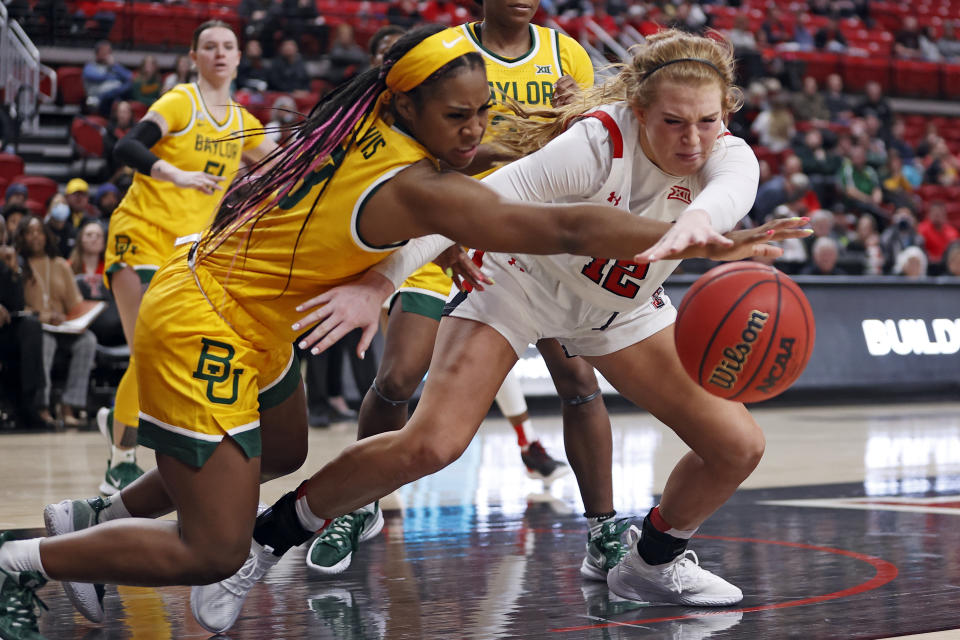 Baylor's Jordan Lewis (3) and Texas Tech's Vivian Gray (12) reach out for a loose ball during the second half of an NCAA college basketball game on Wednesday, Jan. 26, 2022, in Lubbock, Texas. (AP Photo/Brad Tollefson)