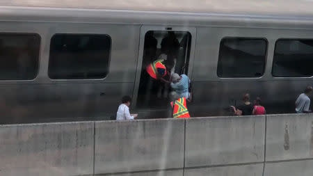 Passengers are evacuated from a train that stopped on the tracks due to an island-wide power outage in La Milla de Oro, Hato Rey, Puerto Rico, in this still image taken from video obtained from social media on April 18, 2018. Twitter/ @yosoyevra/via Reuters