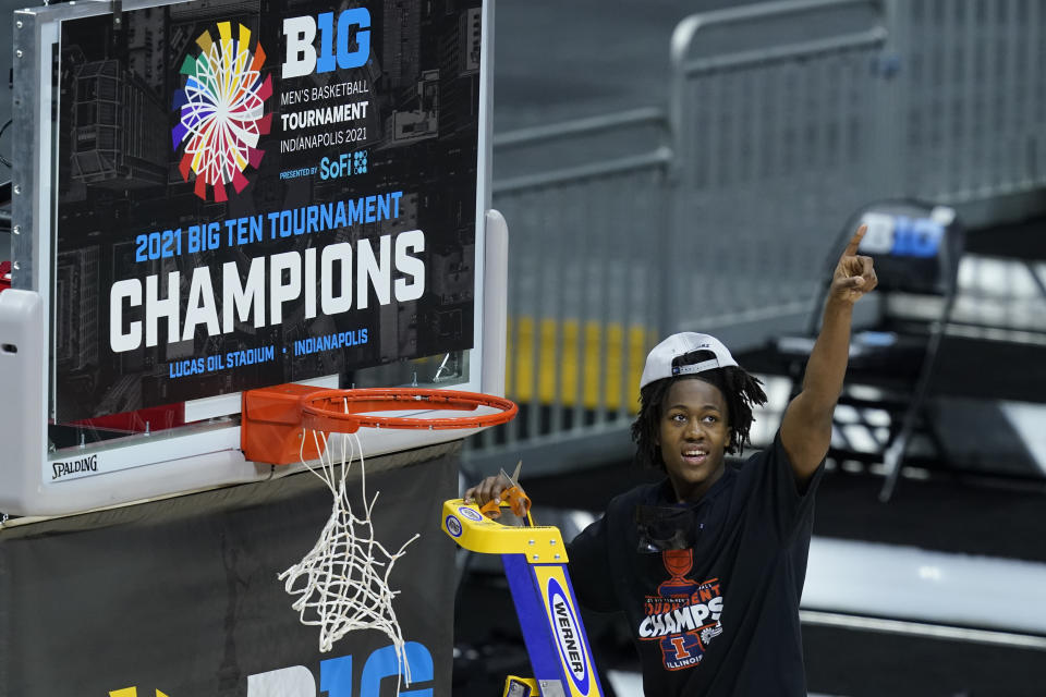 Illinois's Ayo Dosunmu celebrates as he cuts the net after Illinois defeated Ohio State in overtime of an NCAA college basketball championship game at the Big Ten Conference tournament, Sunday, March 14, 2021, in Indianapolis. (AP Photo/Darron Cummings)