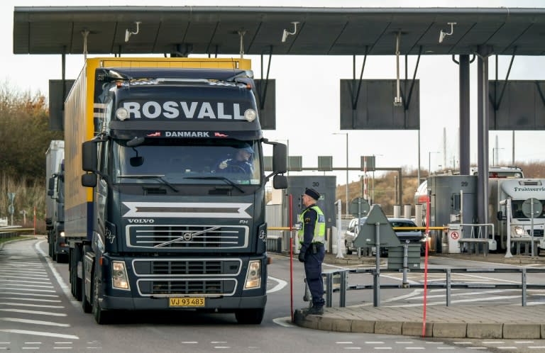 Police and customs personnel stop a freight truck at the toll booth at the Swedish end of the bridge between Sweden and Denmark in Malmo, Sweden, on November 12, 2015