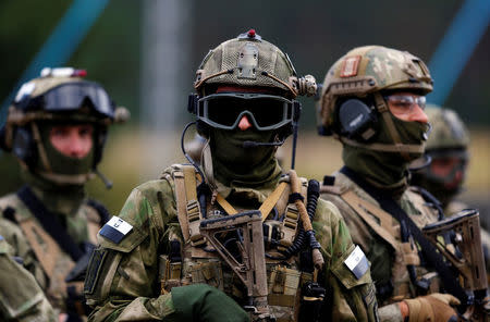 Members of Poland's special commando unit Lubliniec look on during the "Noble Sword-14" NATO international tactical exercise at the land forces training centre in Oleszno, Poland, September 9, 2014. REUTERS/Kacper Pempel/File Photo
