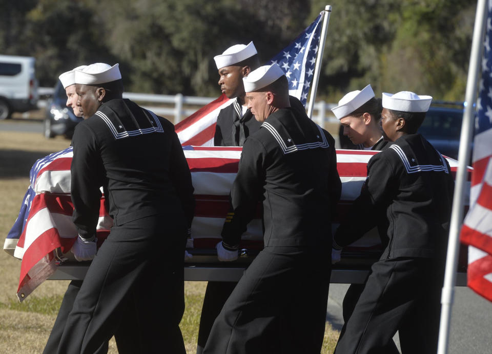 FILE - In this Dec. 16, 2019 file photo, sailors carry the casket of Cameron Walters at Oak Hill Cemetery in Richmond Hill, Ga. Walters was one of the three Navy sailors killed in a Saudi gunman's attack at Pensacola Naval Air Station in Florida on Dec. 6. The FBI has found a link between the gunman in a deadly attack at a military base last December and an al-Qaida operative. That's according to a U.S. official who spoke to The Associated Press on Monday. (Steve Bisson/Savannah Morning News via AP)