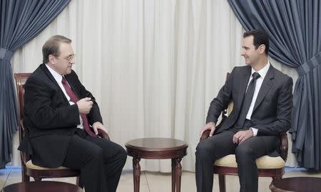 Syria's President Bashar al-Assad (R) meets Russia's Deputy Foreign Minister Mikhail Bogdanov in Damascus December 10, 2014 in this picture released by Syria's national news agency SANA. REUTERS/SANA/Handout via Reuters
