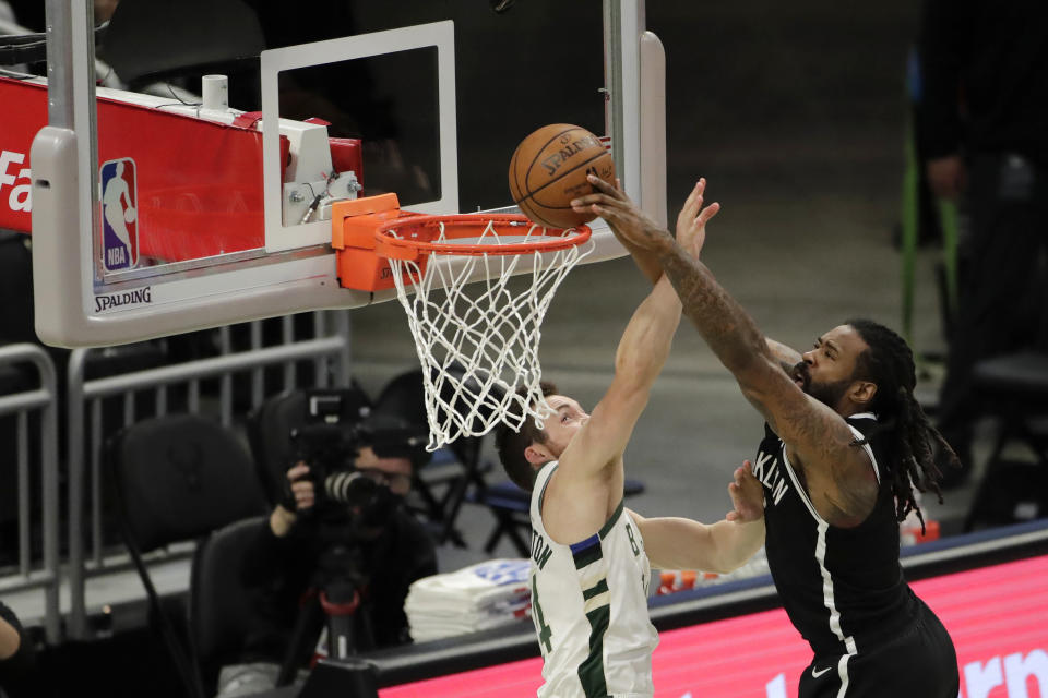 Brooklyn Nets' DeAndre Jordan is fouled by Milwaukee Bucks' Pat Connaughton as he attempts a shot during the first half of an NBA basketball game Tuesday, May 4, 2021, in Milwaukee. (AP Photo/Aaron Gash)