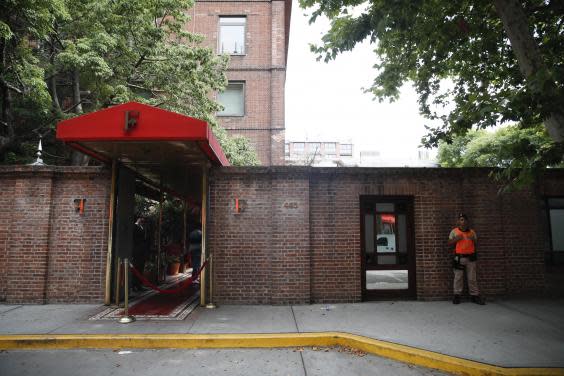 A naval official guards the entrance of the Faena Art Hotel in Buenos Aires, Argentina, hours after motorcycle robbers shot one British tourist dead and injured another, 14 December, 2019. (Natacha Pisarenko/AP)