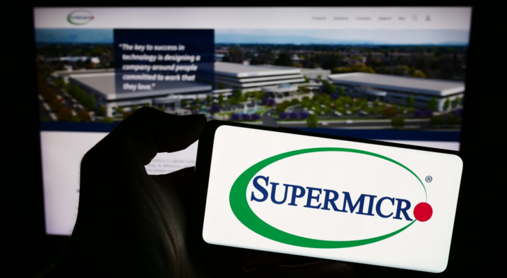 Person holding smartphone with logo of US company Super Micro Computer Inc. (Supermicro) in front of website. Focus on phone display. Unmodified photo. SMCI stock