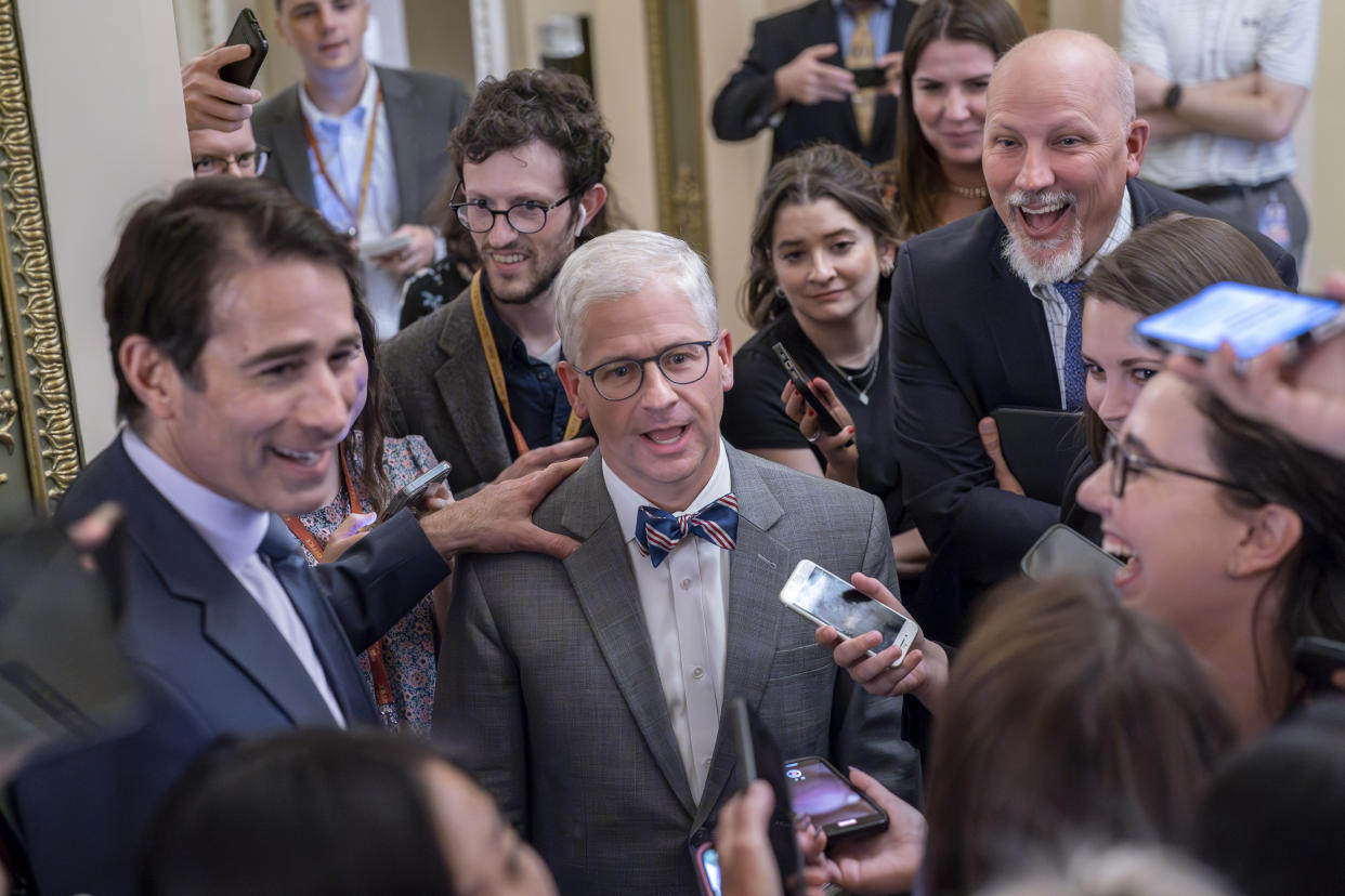 FILE - Top Republican debt crisis mediators Rep. Garret Graves, R-La., left, and Rep. Patrick McHenry, R-N.C., center, chairman of the House Financial Services Committee, with Rep. Chip Roy, R-Texas, upper right, have a laugh as they stop for questions by reporters on progress in the talks with the Biden administration, at the Capitol in Washington, Tuesday, May 23, 2023. Rep. Chip Roy, R-Texas, a member of the conservative House Freedom Caucus, has blasted the tentative debt ceiling deal struck by Speaker Kevin McCarthy, R-Calif., and President Joe Biden and says he will try to stop it in the House. (AP Photo/J. Scott Applewhite, File)