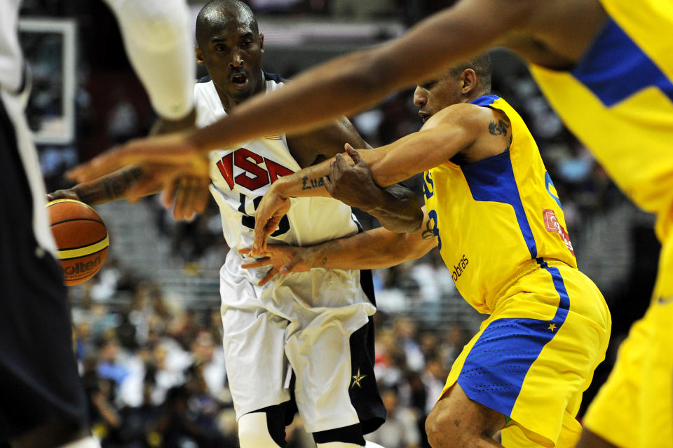 WASHINGTON, DC - JULY 16: Kobe Bryant #10 of the US Men's Senior National Team dribbles past Brazil defenders in the first quarter during a pre-Olympic exhibition basketball game at the Verizon Center on July 16, 2012 in Washington, DC. (Photo by Patrick Smith/Getty Images)