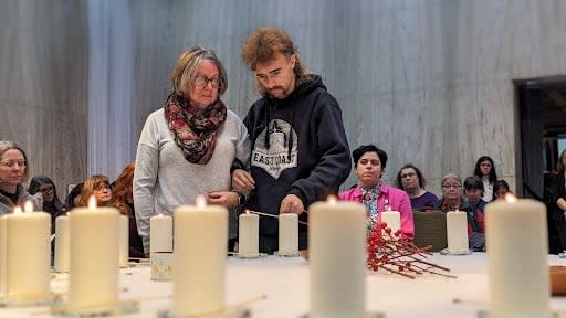 Family and friends of the 10 women who have died since 1989 on P.E.I. because of gender-based violence lit candles to remember them.  (Shane Hennessey/CBC News - image credit)