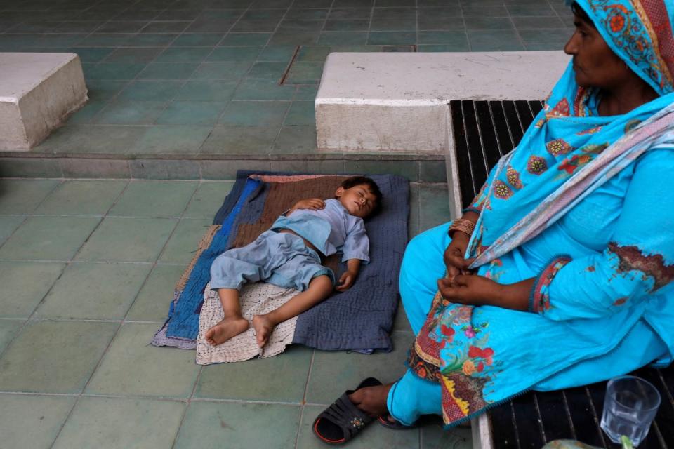 A grandmother visits her grandson while he sleeps (Reuters)