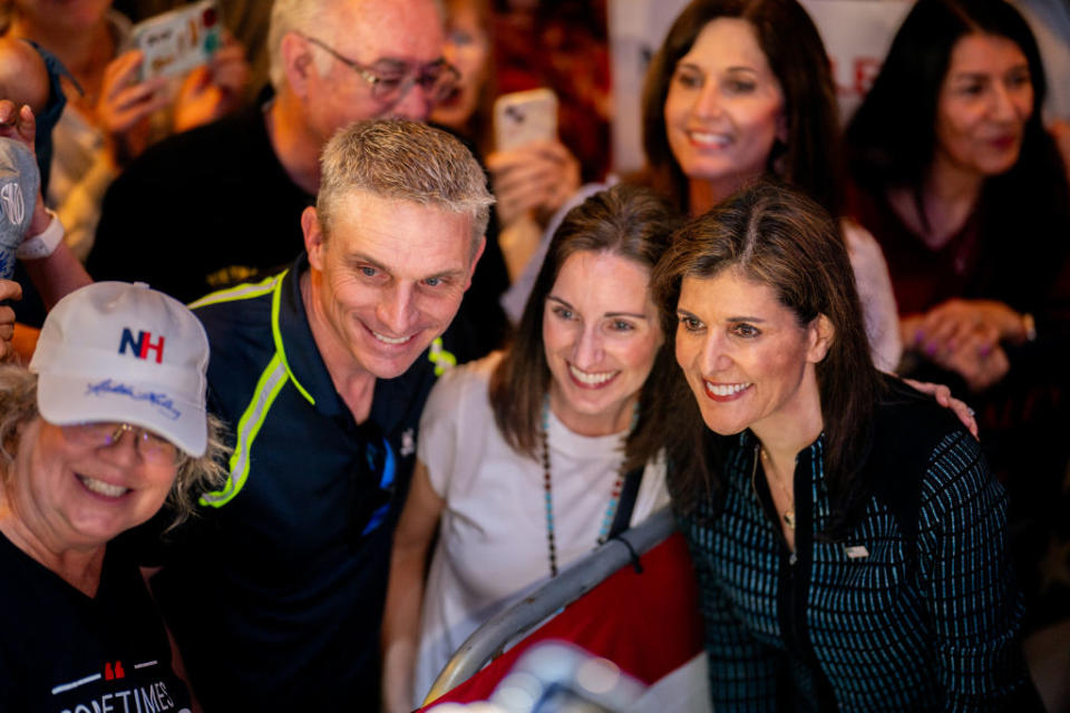 Then-Republican presidential candidate Nikki Haley takes pictures with attendees of a campaign rally at the Sawyer Park Icehouse bar in Spring, Texas, on March 4, 2024. (Photo by Brandon Bell/Getty Images)