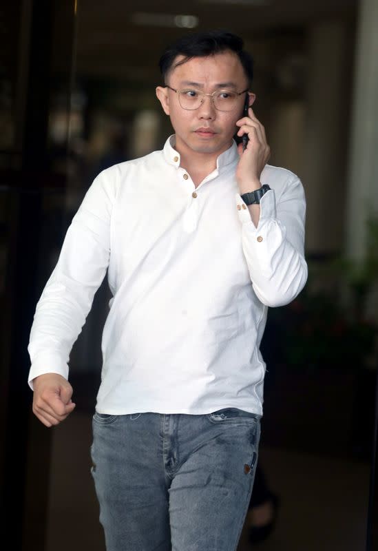 Tan Tong Han, owner of Black Tidings, leaves a court in Singapore