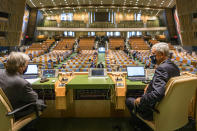 In this photo provided by the United Nations, Secretary-General António Guterres, left, speaks with Volkan Bozkir, president of the seventy-fifth session of the United Nations General Assembly, ahead of the General Assembly's seventy-fifth session, Tuesday, Sept. 22, 2020, at U.N. headquarters in New York. The U.N.'s first virtual meeting of world leaders started Tuesday with pre-recorded speeches from some of the planet's biggest powers, kept at home by the coronavirus pandemic that will likely be a dominant theme at their video gathering this year. (Rick Bajornas/UN via AP)