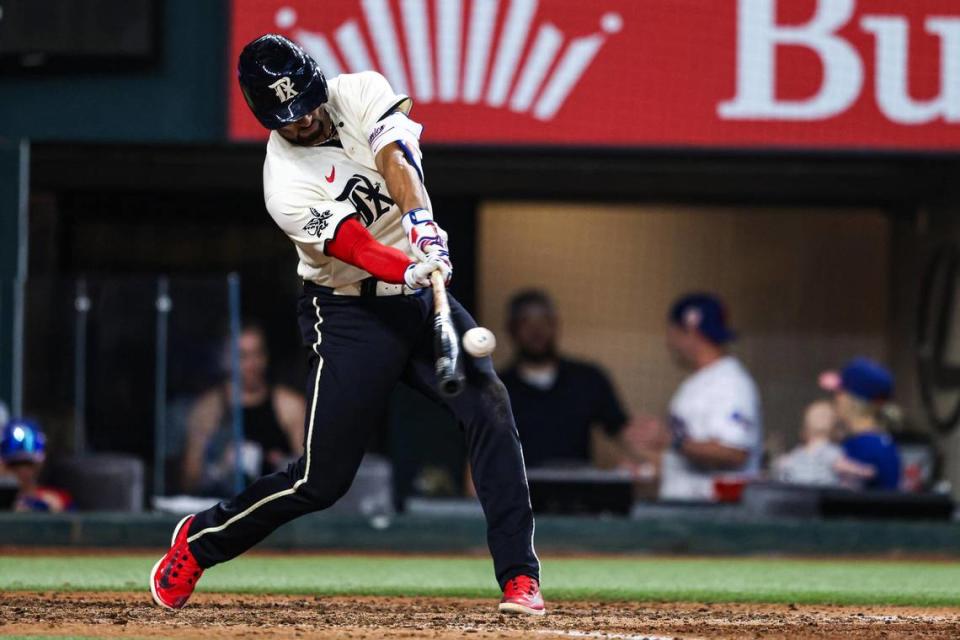 Texas Rangers infielder Marcus Semien (2) hits the ball for a leadoff home run in the first inning of a regular season match up against the Los Angeles Dodgers at Globe Life Field in Arlington, Texas on Saturday, July 22, 2023. Semien’s home run was his 200th of his career.