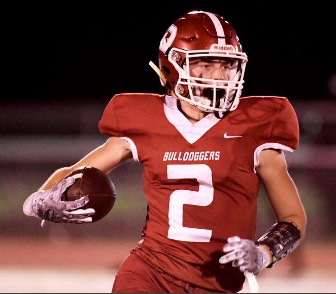 Dewey High School's Bryce Sickler mades a wide swath as he runs during football action on Oct. 12, 2023, against Inola High School.