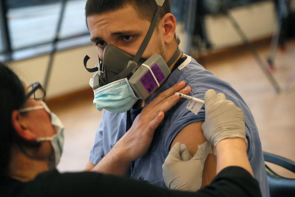 Nicholas Braga, who works in the emergency room at Rhode Island Hospital in Providence, was one of the first to receive the COVID-19 vaccine there on Dec. 14, 2020. (Suzanne Kreiter/The Boston Globe via Getty Images)