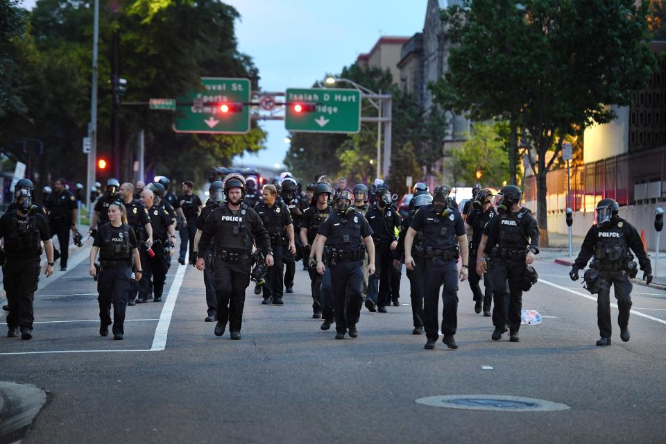 JSO officers move down East Monroe Street toward Main Street as they cleared the last pockets of protesters from downtown Jacksonville in May 2020.