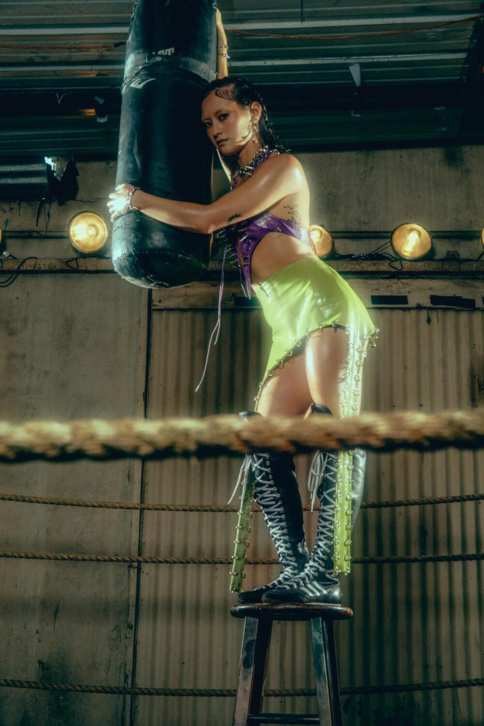 Boxer hangs on punching bag.