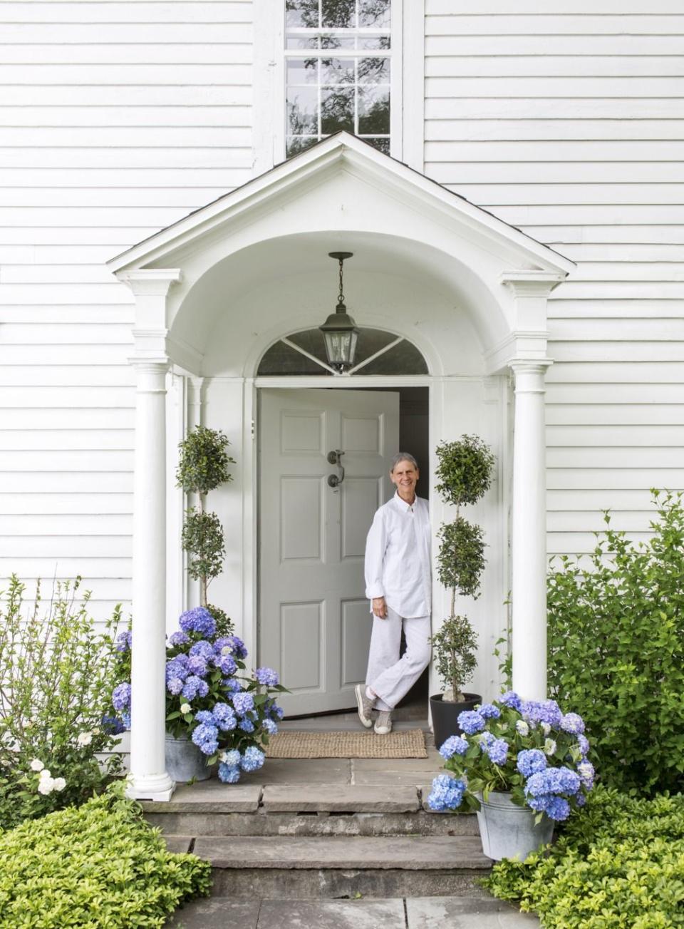 <p>Neutral fanatic and <em>Country Living</em> frequenter Nancy Fishelson welcomes guests to her Orchard Park, New York home with a bit of punchy flower power and complementary elongated topiaries. </p><p><strong><a href="https://www.countryliving.com/home-design/house-tours/g4/reinventing-1795-connecticut-house-0207/" rel="nofollow noopener" target="_blank" data-ylk="slk:Read more on Nancy Fishelson;elm:context_link;itc:0;sec:content-canvas" class="link ">Read more on Nancy Fishelson</a>. </strong></p><p><a class="link " href="https://go.redirectingat.com?id=74968X1596630&url=https%3A%2F%2Fwww.etsy.com%2Fsearch%3Fq%3Dgalvanized%2Bbucket%2Bflower%2Bpots&sref=https%3A%2F%2Fwww.countryliving.com%2Fgardening%2Fgarden-tours%2Fg1432%2Flandscaping-ideas%2F" rel="nofollow noopener" target="_blank" data-ylk="slk:SHOP GALVANIZED BUCKET FLOWER POTS;elm:context_link;itc:0;sec:content-canvas">SHOP GALVANIZED BUCKET FLOWER POTS</a></p>