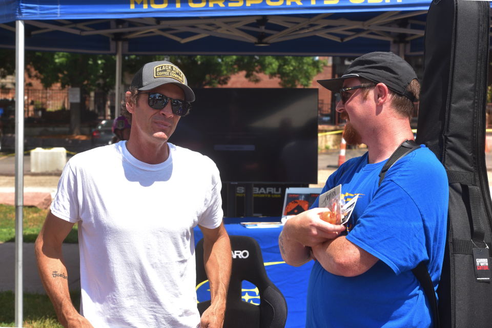 Bucky Lasek, left, talks with an Innoskate attendee near the Schulte Subaru booth.