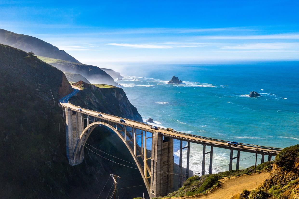 Aerial of Bixby Creek Bridge on the Pacific Coast Highway, California with bridge in the foreground along the coast with the ocean in the background
