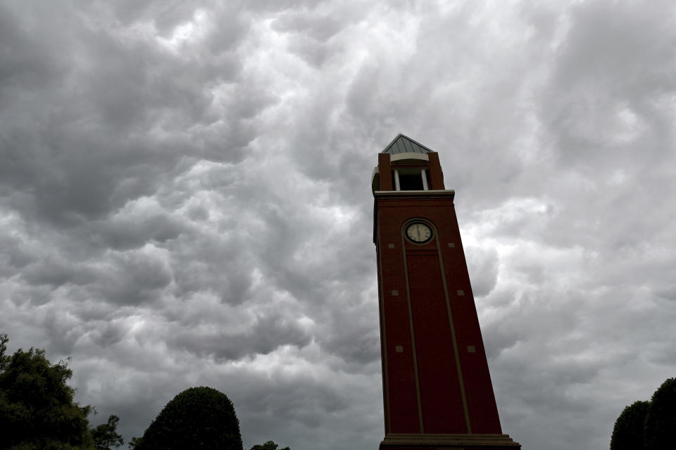 Storm clouds pass over the clock tower in the Village of Lake Park in Union County, N.C., on Monday, Aug. 7, 2023. (Jeff Siner/The Charlotte Observer via AP)