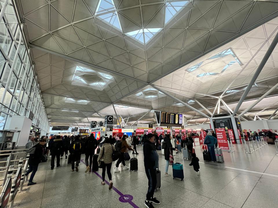 Passengers walking through Stansted Airport on April 15, 2024