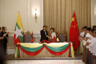 Myanmar State Counselor Aung San Suu Kyi, center right, and Chinese President Xi Jinping shake hands after the ceremony of signing a memorandum of understanding (MOU) at president house in Naypyitaw, Myanmar, Saturday, Jan. 18, 2020. (Nyein Chan Naing/Pool Photo via AP)