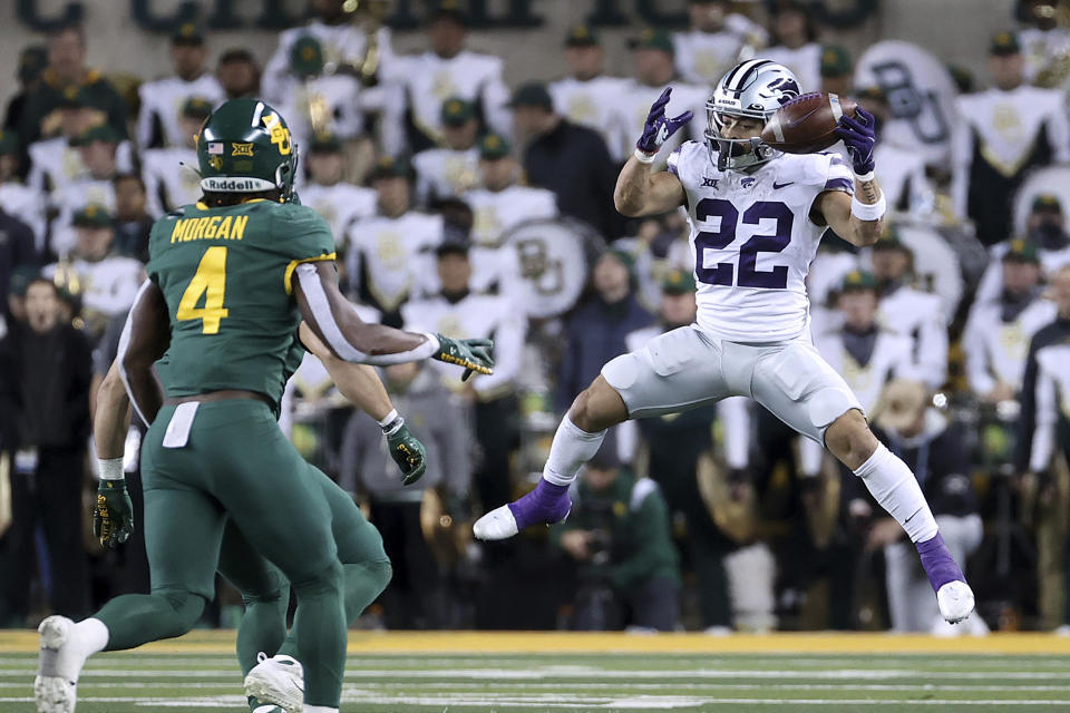 Kansas State running back Deuce Vaughn (22) catches a pass against Baylor safety Christian Morgan in the second half of an NCAA college football game, Saturday, Nov. 12, 2022, in Waco, Texas. (AP Photo/Jerry Larson)