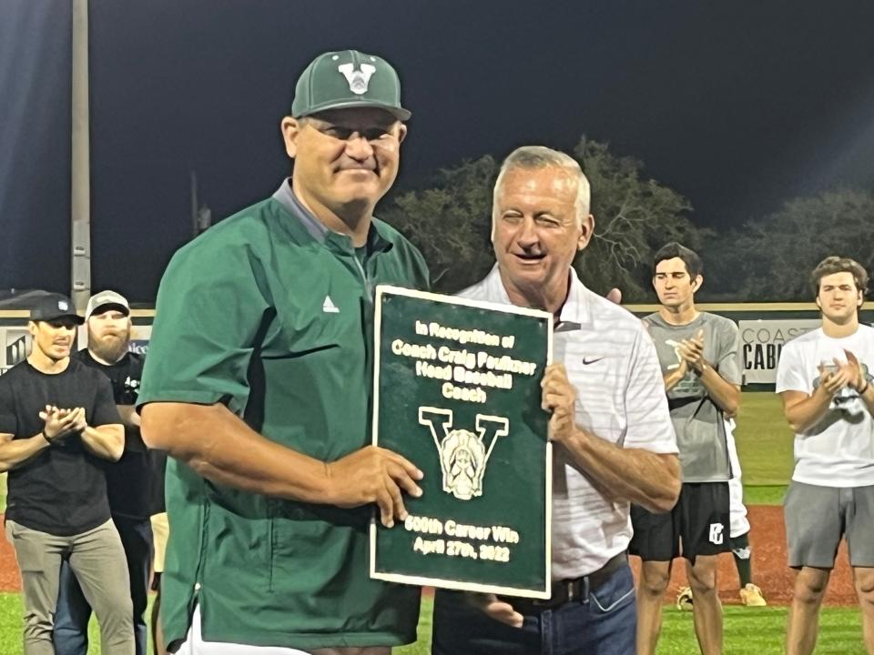 Venice High baseball coach Craig Faulkner receives a plaque from Director of Athletics Pete Dombroski on Monday evening after Faulkner won his 500th game earlier in the season.