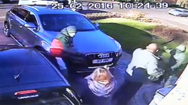 The robbers emerge from the white car and attack the 57-year-old man, demanding his keys. Photo: UK Police