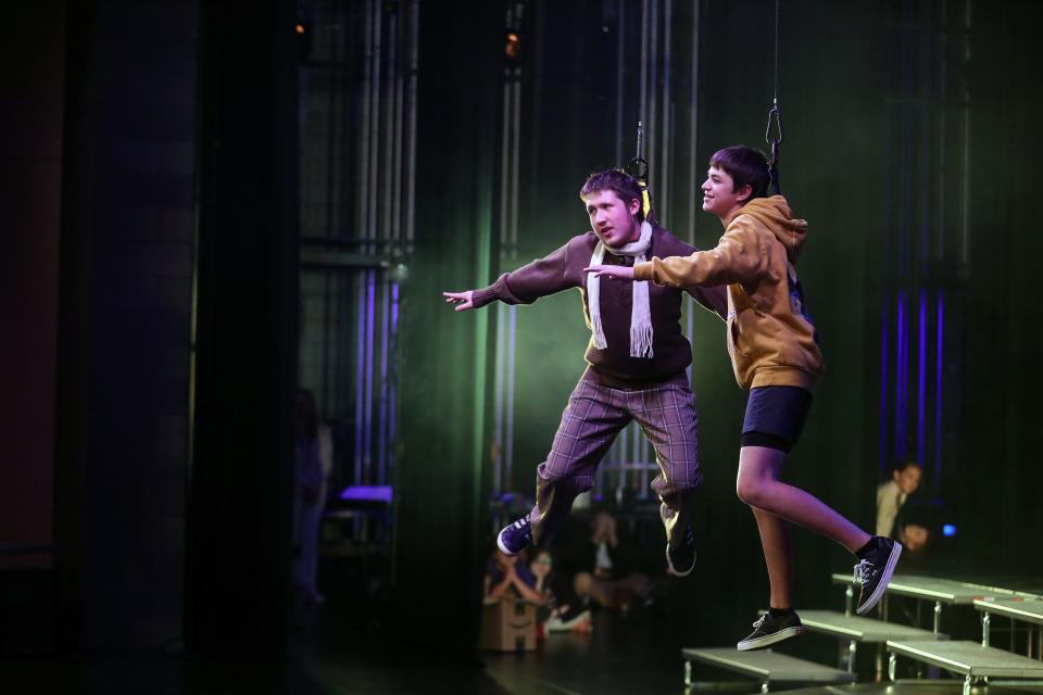 Grandpa Joe (played by Riley Franco) and Charlie (played by Miles Borer) float in the air with help from harnesses during rehearsal for Central Kitsap School District's summer musical: Willy Wonka at the CKHS Auditorium on Friday, Aug. 5, 2022.