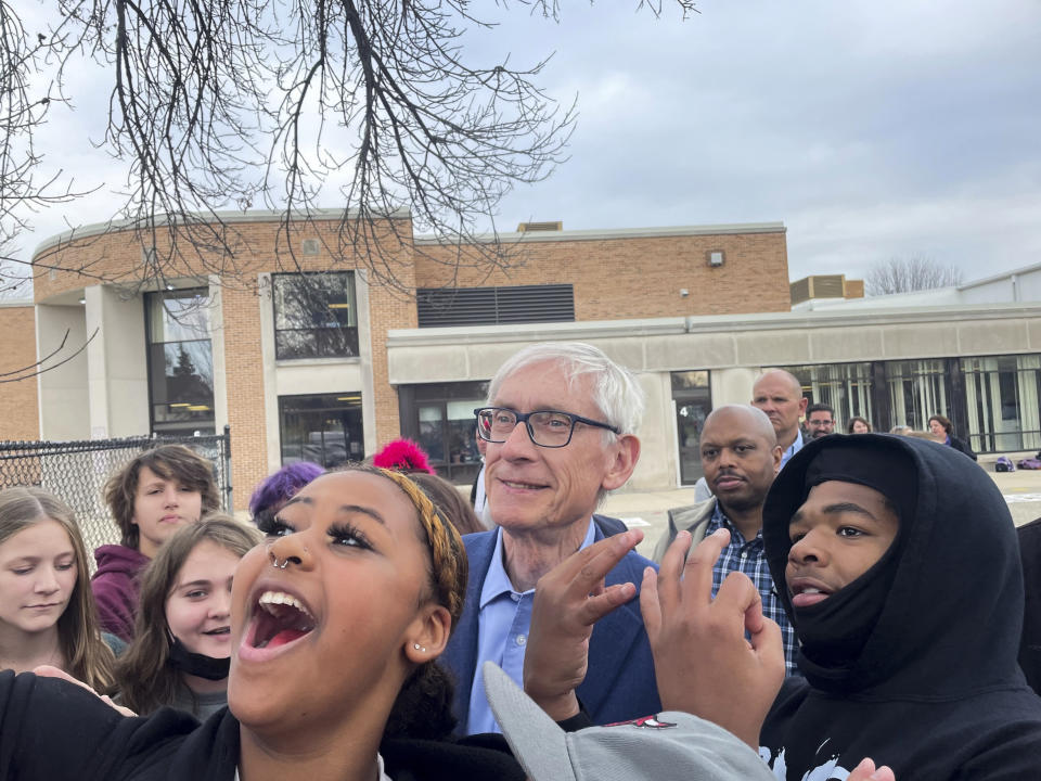 Wisconsin Gov. Tony Evers takes photos with teachers and students at Georgia O'Keeffe Middle School in Madison, Wisc., on Wednesday, Nov. 9, 2022. The newly reelected governor beat out Republican candidate Tim Michels in what has been a hotly contested race. (AP Photo/Harm Venhuizen)